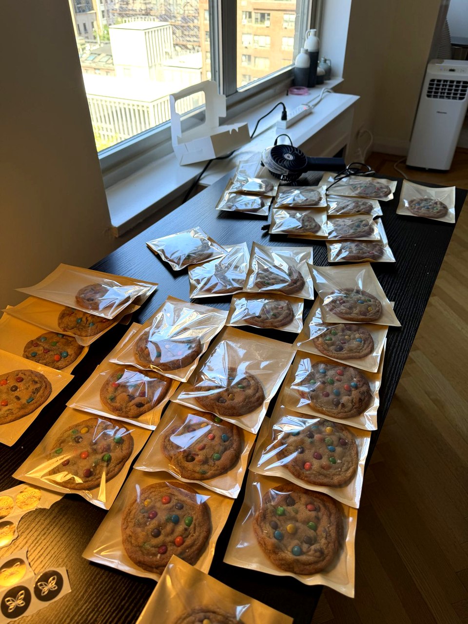 The packing table at dusk, given over entirely to sealed cookies